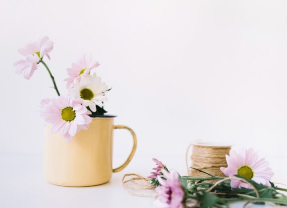 A bright and airy aesthetic featured image for a blog post about March quotes, featuring a vase of fresh tulips and a morning coffee on a sunlit wooden table, representing spring new beginnings.