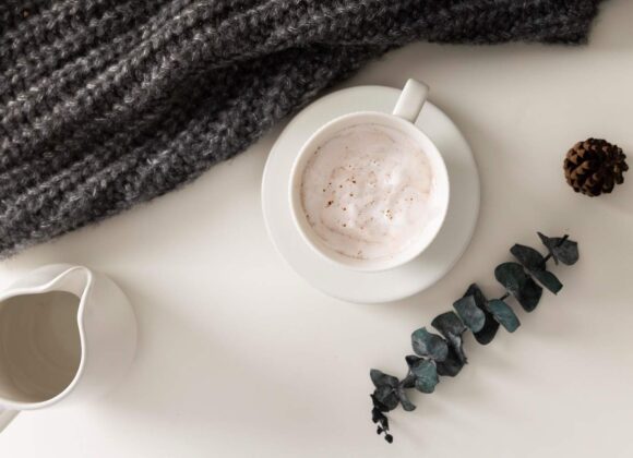 Cozy Self-Care Sunday setup with coffee, journal, candle, and blanket for relaxation and inspiration