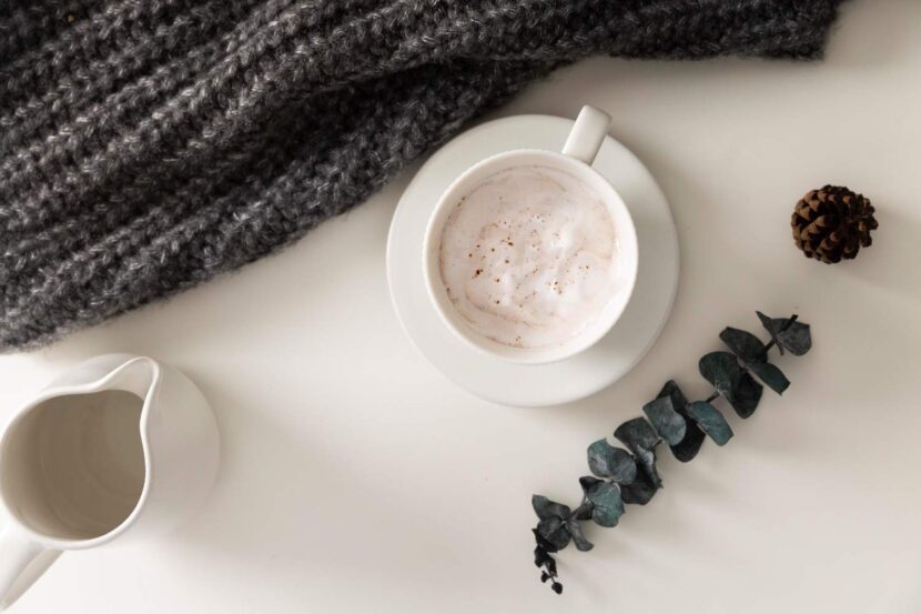 Cozy Self-Care Sunday setup with coffee, journal, candle, and blanket for relaxation and inspiration