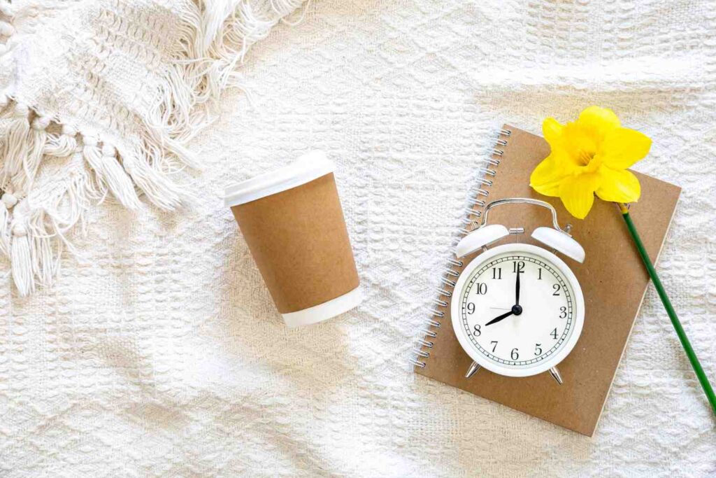 Warm sunrise alarm light glowing in a cozy fall bedroom