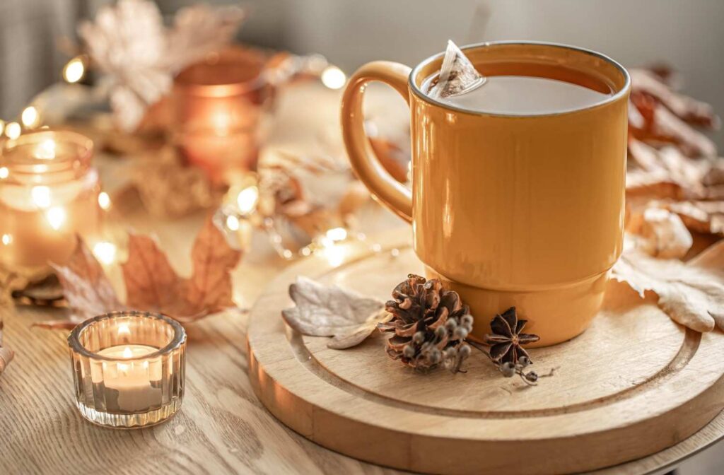 Hands wrapped around a warm mug of tea during a slow fall morning